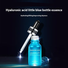 Blue bottle of hyaluronic acid essence with dropper on a dark background